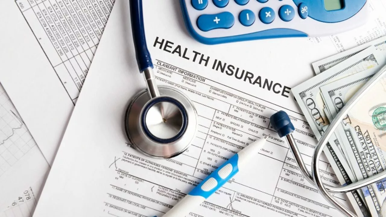 Are Health Insurance Premiums Tax Deductible illustration with tax forms, calculator, and a health insurance card.